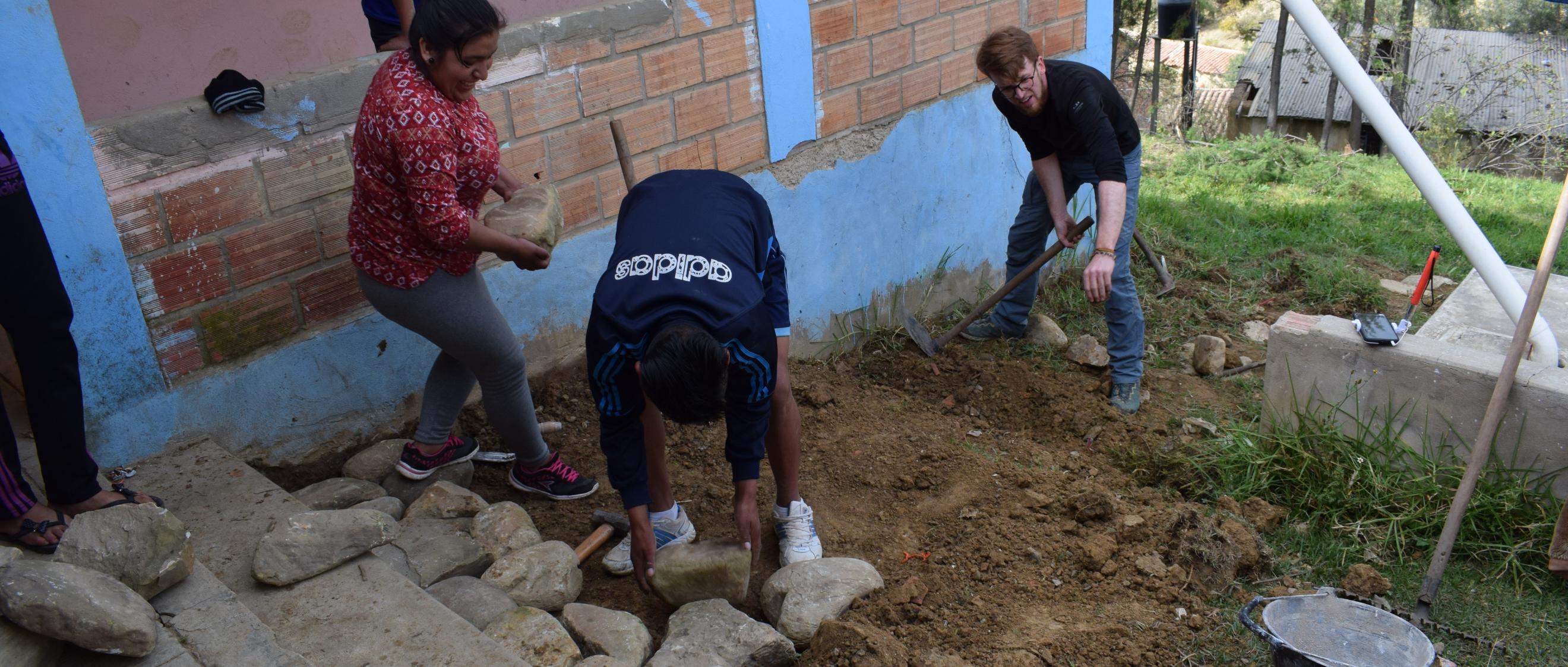 Das Bild junge Menschen beim Bau einer Terrasse während der 72h Aktion in Bolivien