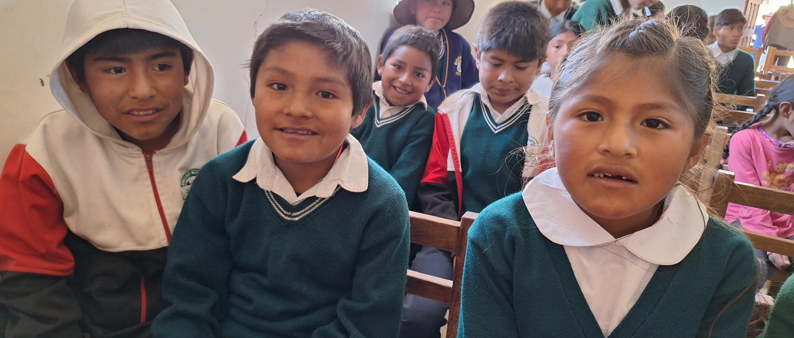 Das Bild zeigt Kinder auf Bänken in einer Kirche. Es ist ein Gottesdienst in Buena Vista in Bolivien.