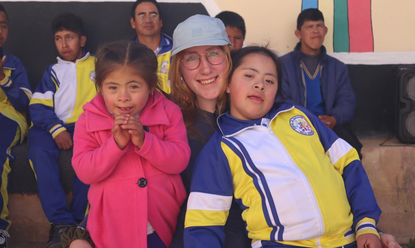 Das Bild zeigt eine junge Dame die zwei Kinder im Arm hält.
