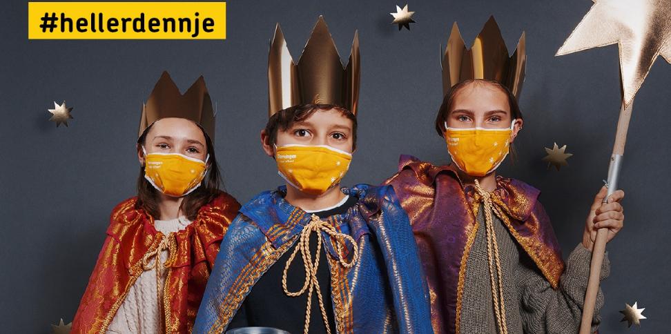 Das Bild zeigt das Sternsinger Plakat von 2021. Drei Kinder als Sternsinger verkleidet tragen Masken.