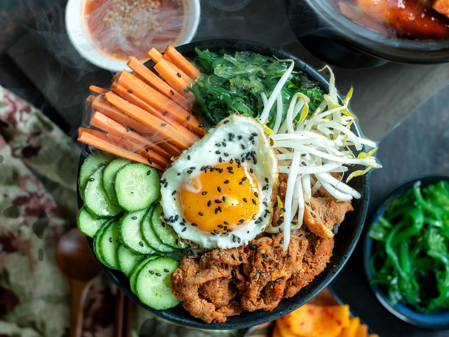 Bibimbap ist ein koreanisches Gericht mit Reis, verschiedenen Gemüsesorten, etwas Rindfleisch oder Tofu, einem rohen oder gebratenem Ei und Gochujang (Chilipaste)